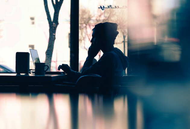 silhouette-of-a-person-sitting-in-front-of-a-laptop.jpg silhouette of a person sitting in front of a laptop